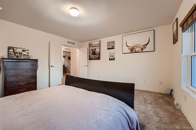 carpeted bedroom with a textured ceiling