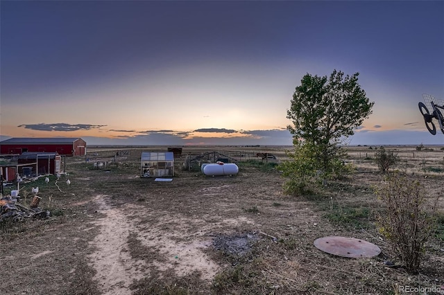 yard at dusk with a rural view