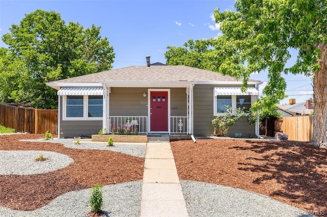 951 S Osage St, Denver, CO 80223 - bungalow featuring a porch and a shingled roof