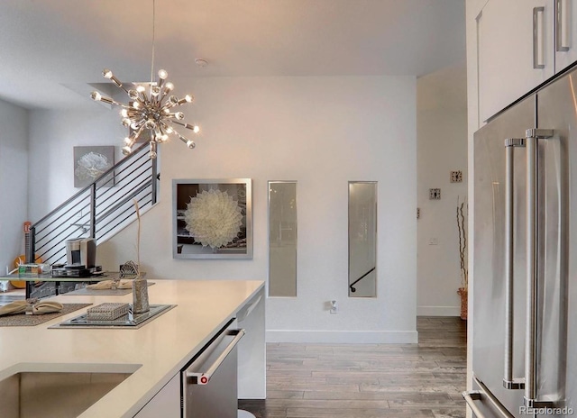 3030 Wilson Ct Unit 5, Denver, CO 80205 - corridor with light wood-type flooring and a chandelier