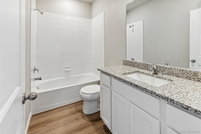 2171 Christina St, Fort Lupton, CO 80621 - bathroom with wood finished floors, toilet, tub / shower combination, and vanity