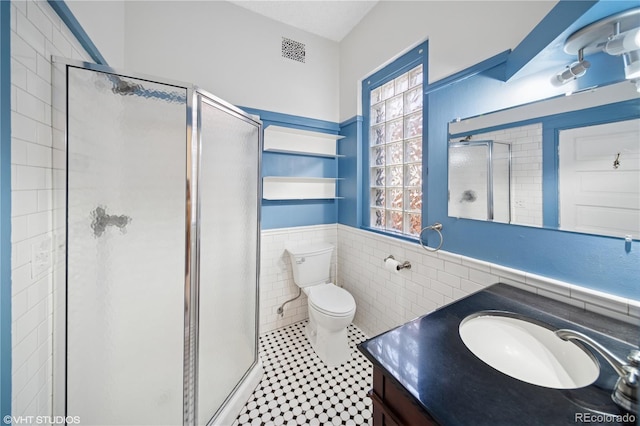 3817 Osage St, Denver, CO 80211 - full bath with a shower stall, vanity, healthy amount of natural light, tile walls, and wainscoting