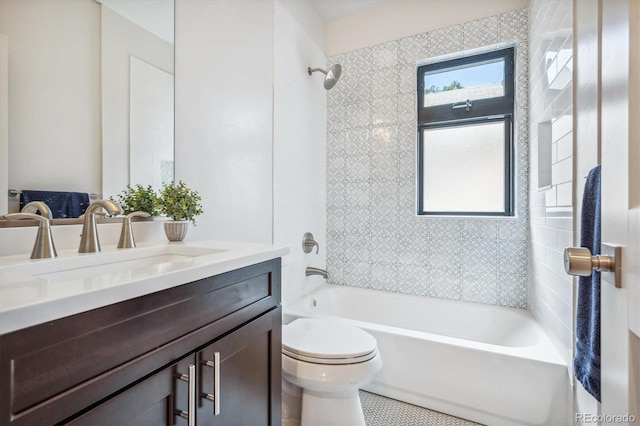 full bathroom with tiled shower / bath, tile patterned floors, toilet, and vanity