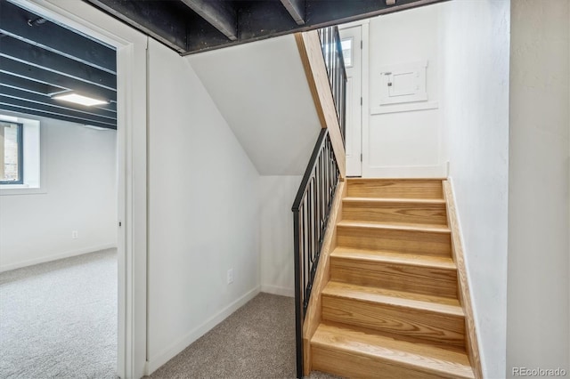 stairs featuring carpet flooring and vaulted ceiling