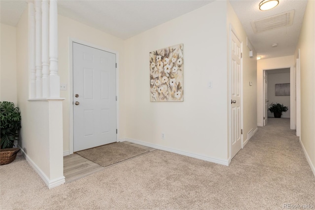 entrance foyer featuring light colored carpet