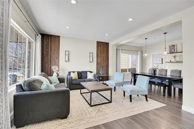 living room with baseboards, wood finished floors, and recessed lighting