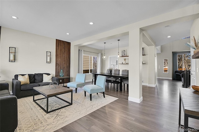 living area with recessed lighting, baseboards, and wood finished floors