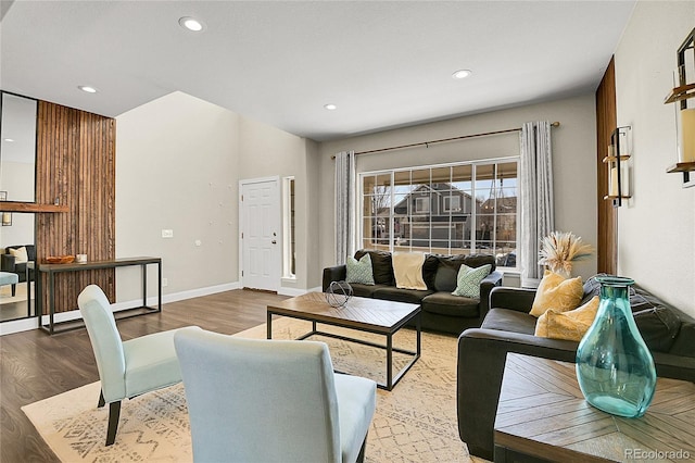 living area featuring recessed lighting, baseboards, and wood finished floors