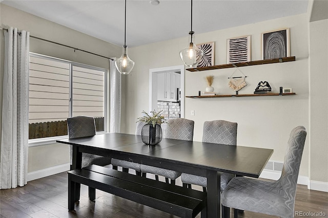 dining room featuring baseboards and wood finished floors