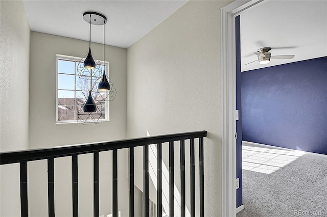 hallway featuring carpet floors and a textured wall