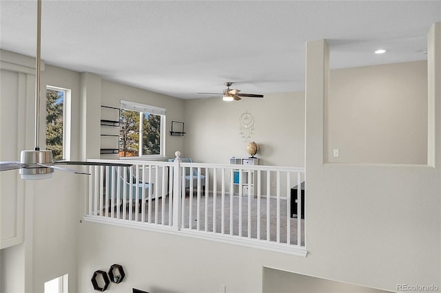 hallway featuring recessed lighting and an upstairs landing