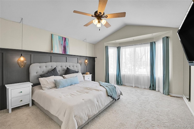 bedroom featuring carpet floors, vaulted ceiling, baseboards, and ceiling fan