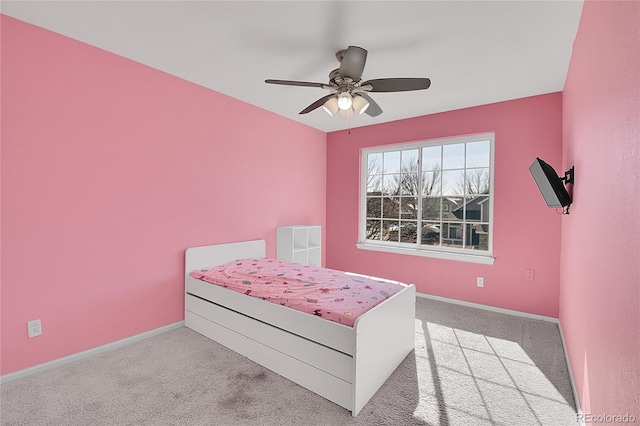 carpeted bedroom featuring ceiling fan and baseboards