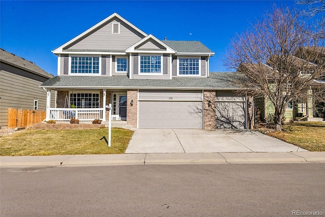 view of front of house featuring covered porch, brick siding, fence, concrete driveway, and a front lawn