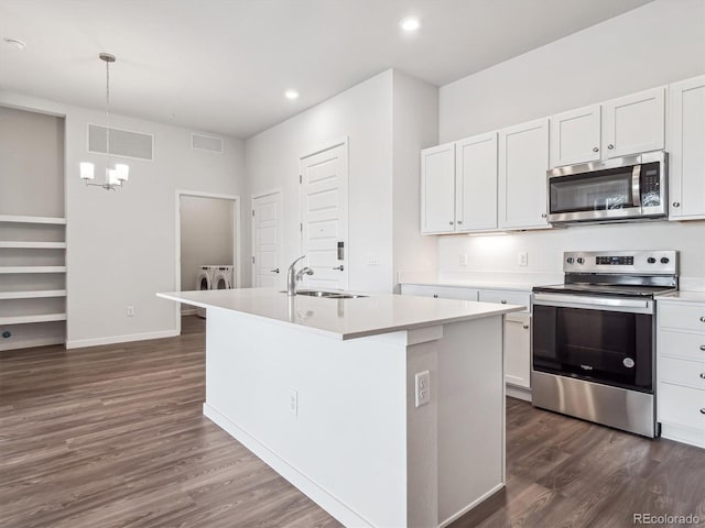 485 Interlocken Blvd Unit 101, Broomfield, CO 80021 - kitchen with stainless steel appliances, washer and dryer, dark wood finished floors, light countertops, and recessed lighting