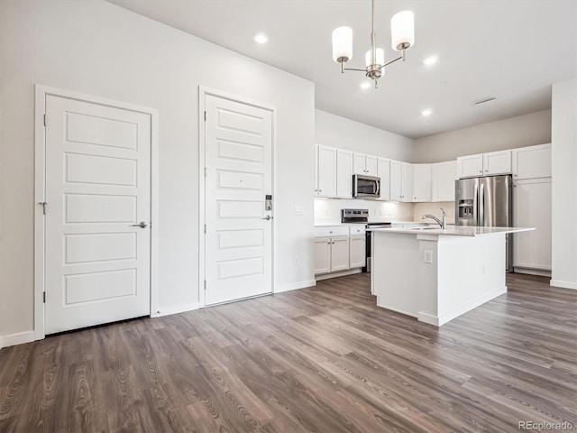 485 Interlocken Blvd Unit 101, Broomfield, CO 80021 - kitchen featuring stainless steel appliances, a chandelier, dark wood-type flooring, light countertops, and recessed lighting
