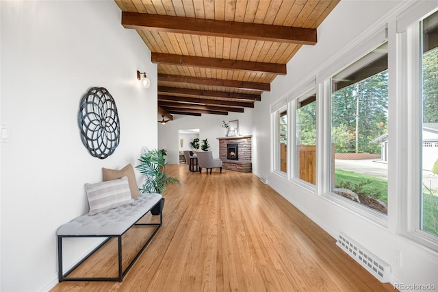 interior space featuring a healthy amount of sunlight, wood ceiling, beamed ceiling, and visible vents