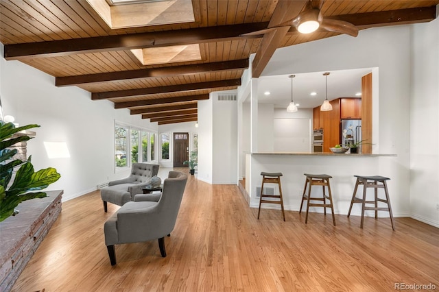 living room featuring visible vents, baseboards, light wood finished floors, and wooden ceiling