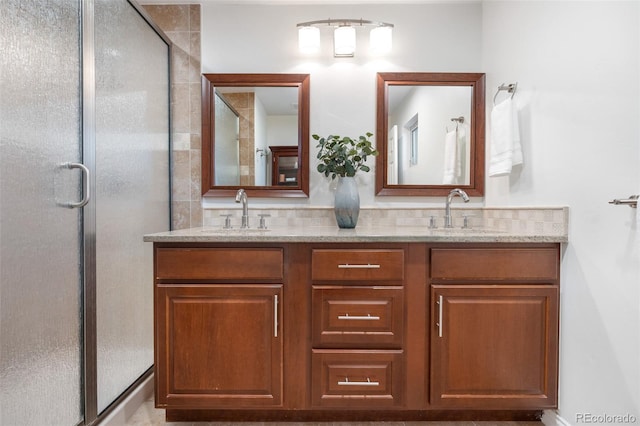 full bathroom featuring a sink, a shower stall, and double vanity