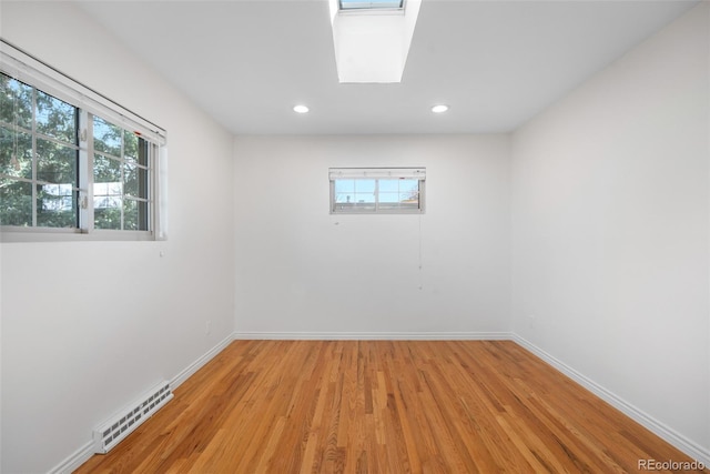 unfurnished room with recessed lighting, baseboards, visible vents, and light wood-type flooring