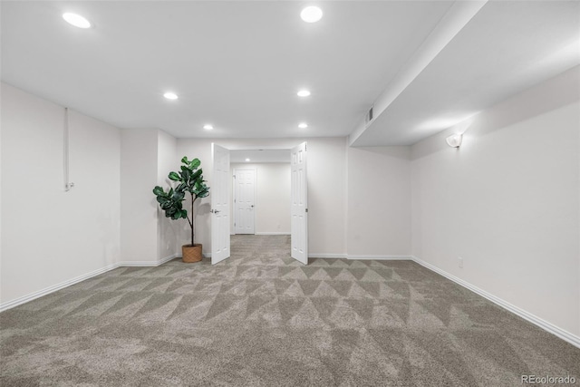 finished basement featuring recessed lighting, baseboards, visible vents, and light carpet