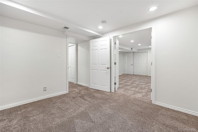 basement featuring carpet floors, baseboards, recessed lighting, and visible vents