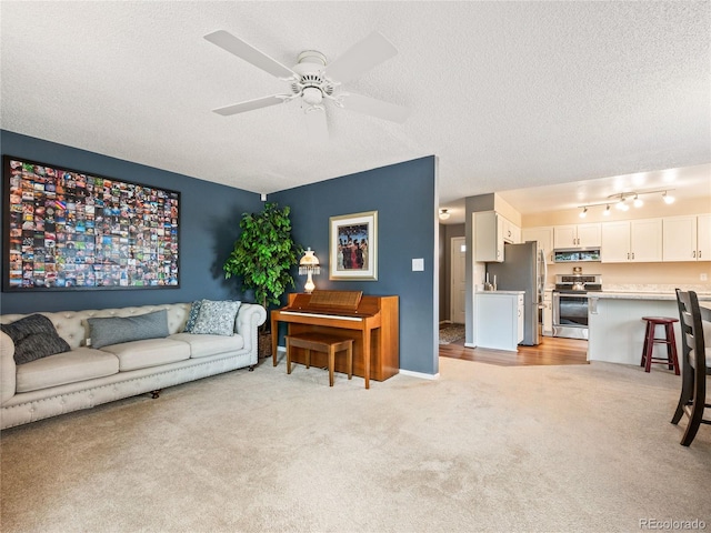 carpeted living room with a textured ceiling and ceiling fan