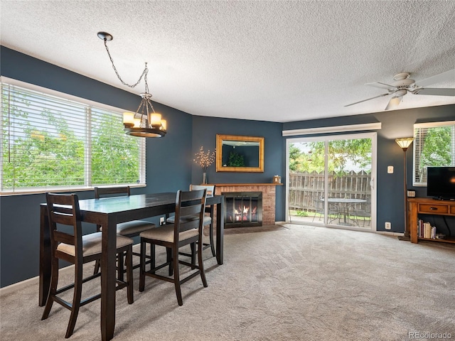 dining space with plenty of natural light and carpet flooring