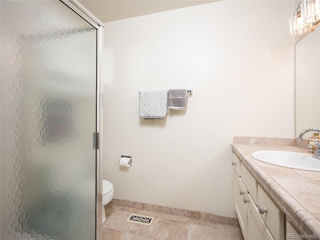 bathroom featuring vanity, toilet, tile patterned floors, and an enclosed shower