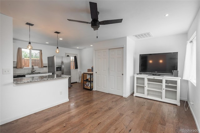 3629 W Custer Pl, Denver, CO 80219 - kitchen with stainless steel refrigerator with ice dispenser, a sink, tasteful backsplash, wood finished floors, and a ceiling fan