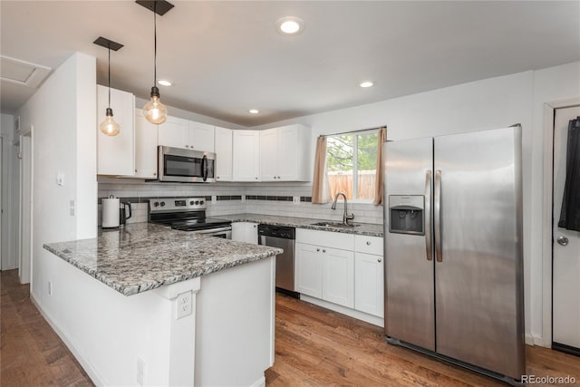 3629 W Custer Pl, Denver, CO 80219 - kitchen with appliances with stainless steel finishes, light stone countertops, a peninsula, a sink, and white cabinetry