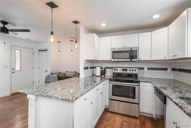 3629 W Custer Pl, Denver, CO 80219 - kitchen with appliances with stainless steel finishes, a peninsula, backsplash, white cabinets, and ceiling fan