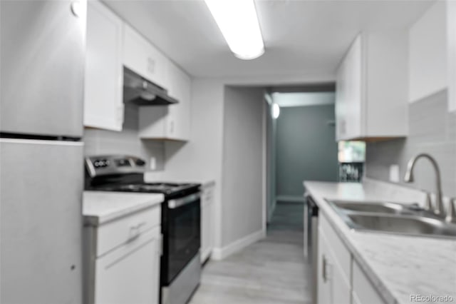 kitchen featuring electric stove, white cabinets, white refrigerator, sink, and ventilation hood