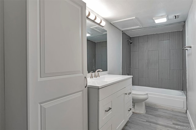 full bathroom with vanity, hardwood / wood-style floors, shower / tub combination, and toilet