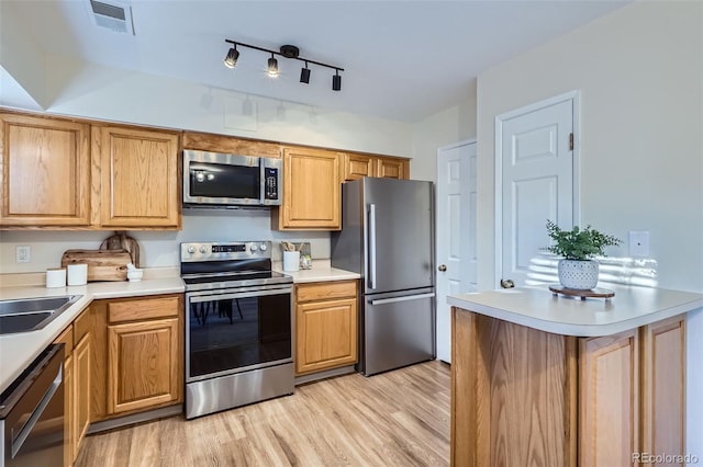 5511 S Lowell Blvd, Littleton, CO 80123 - kitchen with stainless steel appliances, light wood-type flooring, and light countertops