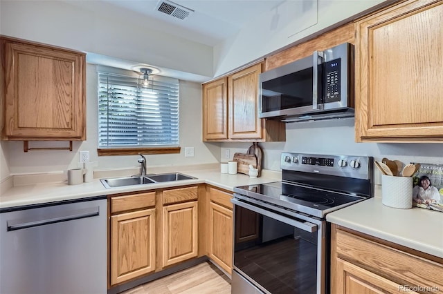 5511 S Lowell Blvd, Littleton, CO 80123 - kitchen with appliances with stainless steel finishes, light countertops, and light wood-style flooring
