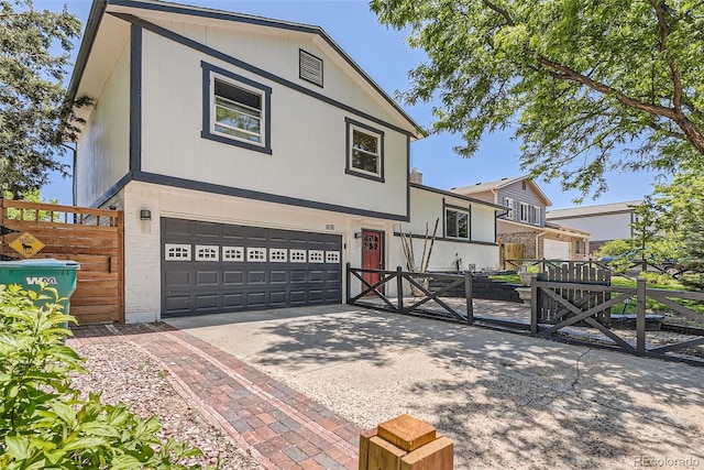 1676 S Fairplay St, Aurora, CO 80012 - tri-level home featuring a gate, a garage, and driveway