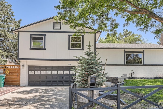 1676 S Fairplay St, Aurora, CO 80012 - view of front of house with a garage, concrete driveway, brick siding, and roof with shingles