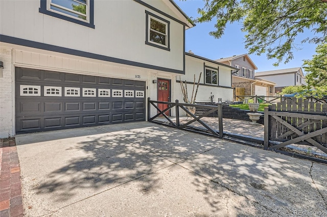 1676 S Fairplay St, Aurora, CO 80012 - tri-level home featuring an attached garage, driveway, and a gate