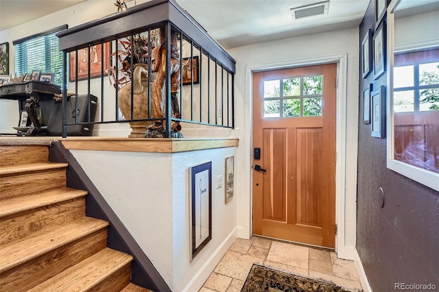 1676 S Fairplay St, Aurora, CO 80012 - foyer featuring stone tile floors, baseboards, and stairs