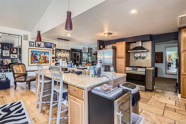 1676 S Fairplay St, Aurora, CO 80012 - kitchen featuring wall chimney exhaust hood, appliances with stainless steel finishes, a kitchen island, light countertops, and a breakfast bar
