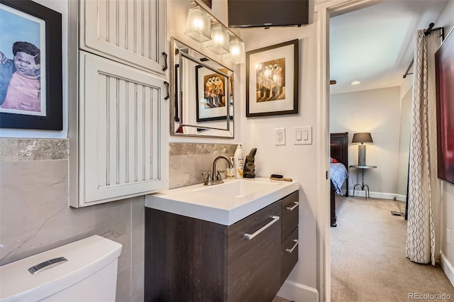 1676 S Fairplay St, Aurora, CO 80012 - bathroom featuring vanity, toilet, ensuite bath, and baseboards