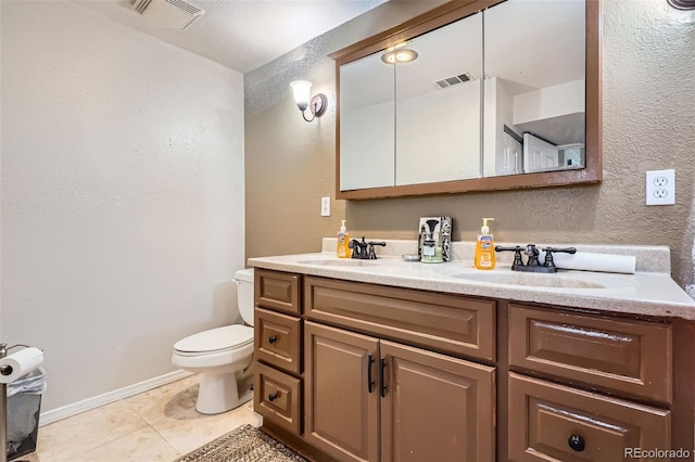 1676 S Fairplay St, Aurora, CO 80012 - bathroom featuring double vanity, toilet, a textured wall, tile patterned floors, and baseboards