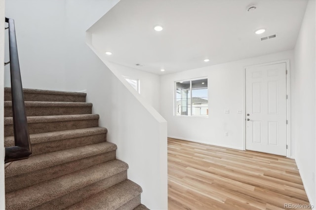 staircase with hardwood / wood-style flooring