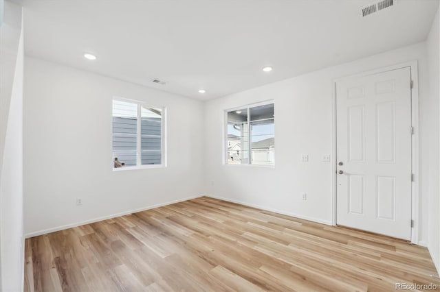 empty room with light hardwood / wood-style floors