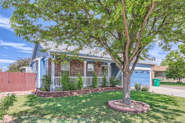 433 N 15th Ave, Brighton, CO 80601 - view of front of house with driveway, brick siding, a garage, and a porch