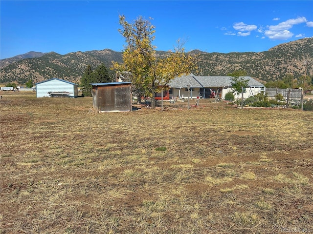 view of yard with a mountain view and an outdoor structure