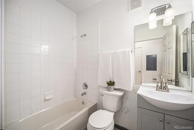 full bathroom featuring vanity, toilet, electric panel, and tiled shower / bath combo