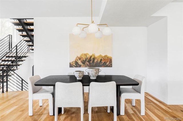 108 Arapahoe St, Golden, CO 80403 - dining room with wood finished floors, baseboards, stairway, and a chandelier