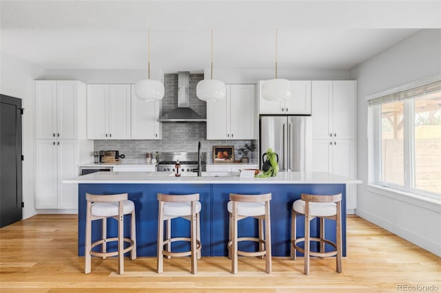 108 Arapahoe St, Golden, CO 80403 - kitchen with wall chimney range hood, freestanding refrigerator, range, decorative backsplash, and light countertops